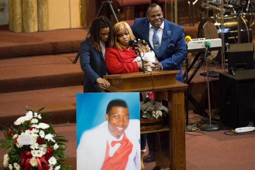 Quintonio LeGrier’s father, Antonio LeGrier (right) and his mother, Janet Cooksey (center) at their son’s funeral in January 2016. | Lou Foglia/Sun-Times file photo