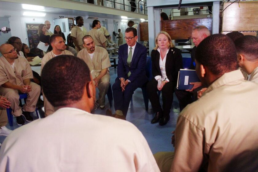Connecticut Gov. Dannel P. Malloy, first lady Cathy Malloy and Correction Department Commissioner Scott Semple speak with inmates inside the Cheshire Correctional Institution in Cheshire, Conn. on Wednesday May 30, 2018. The inmates are part a program des