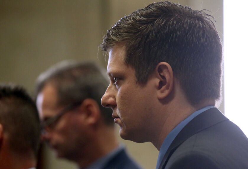 Indicted Police officer Jason Van Dyke, along with his attorneys, stands in front of Judge Vincent Gaughan in the courtroom at the Leighton Criminal Court Building during a hearing in his shooting case of Laquan McDonald on Wednesday, March 23, 2016. (Nan