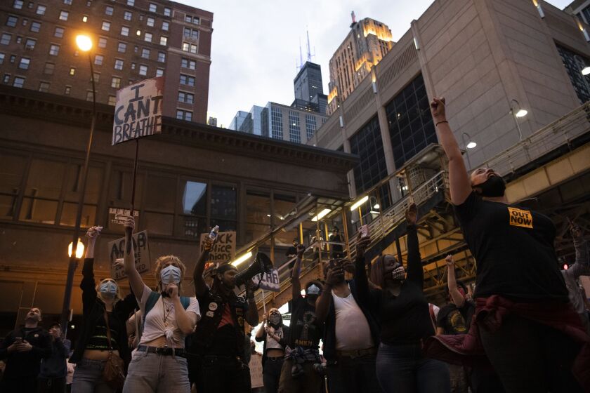 Hundreds of protesters cheer after hearing the pounds and taps on the glass from the prisoners inside the Metropolitan Correctional Center, Friday, May 29, 2020.