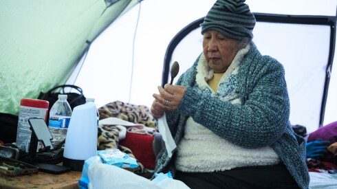 Carmen Laude, 72, cleans spoons in her tent at an encampment near West Admore Avenue at Legion Park in North Park, Monday, March 16, 2026. | Anthony Vazquez/Sun-Times