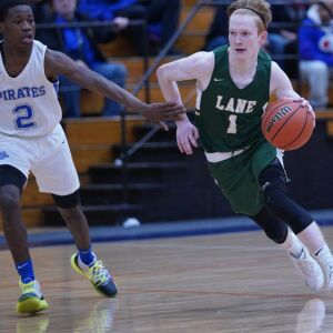 Proviso East’s James Hobson (2) grabs the arm off Lane’s Michael Molloy (1) to slow him down, Wednesday 02-27-19. Worsom Robinson/For Sun-Times