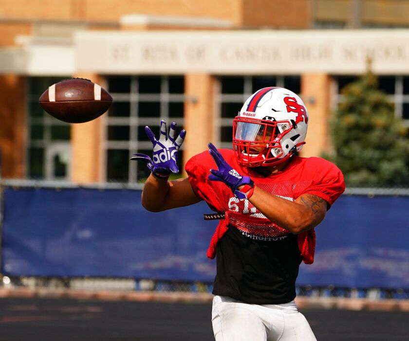 St. Rita’s Kaleb Brown (3) watches the ball into his hands at practice, Monday, August 23, 2021.