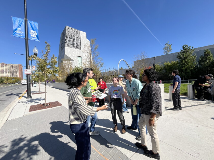 Workers and union organizers hand out stickers and buttons outside of the Obama Presidential Center in Jackson Park on Wednesday.