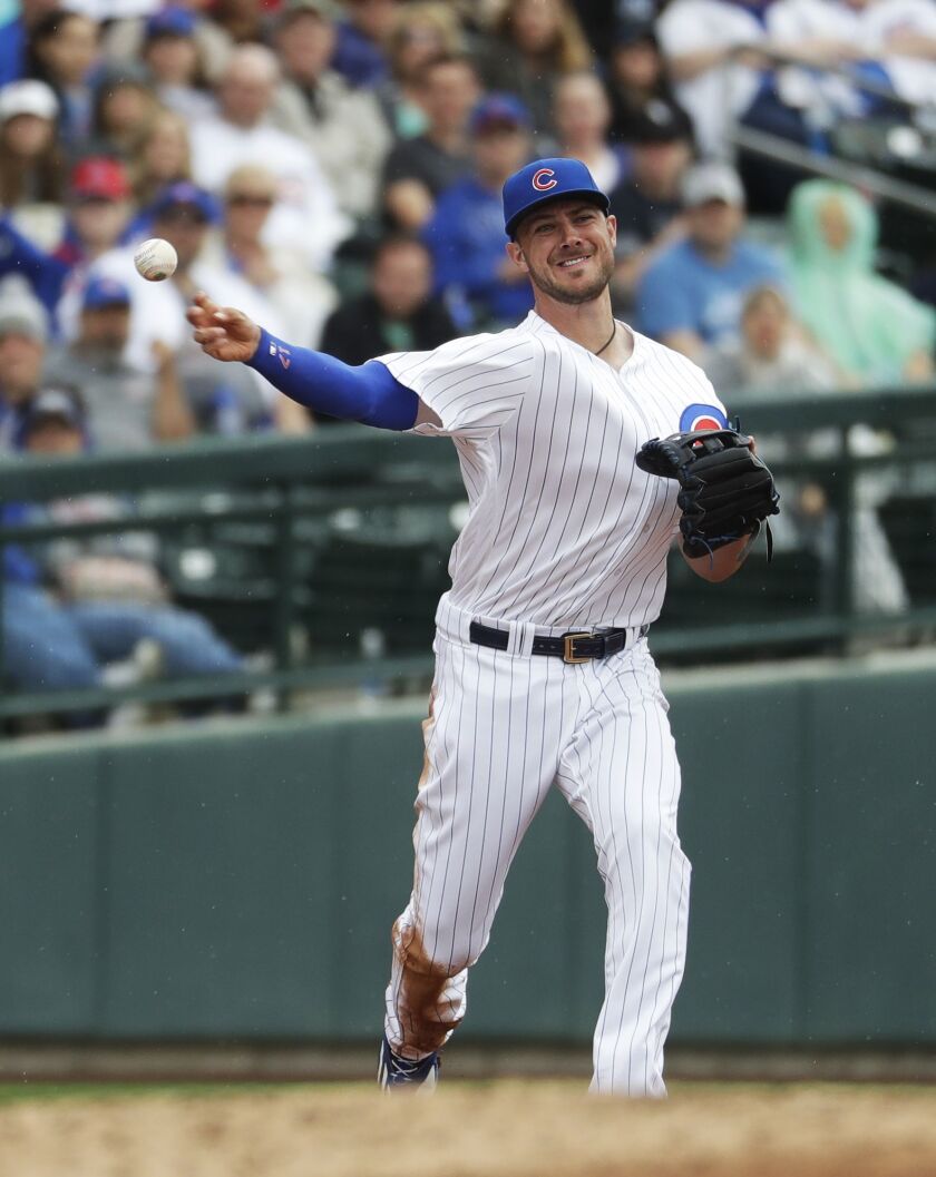 Third baseman Kris Bryant throws across the diamond.