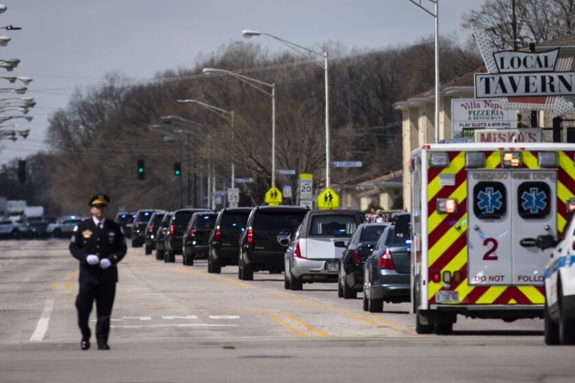 Led by a procession of hundreds of law enforcement vehicles, the hearse carrying Chicago Police Officer Officer Marco DiFranco leaves Cumberland Funeral Chapels and heads toward All Saints Catholic Cemetery & Mausoleum in Des Plaines, Thursday, April 9, 2020.