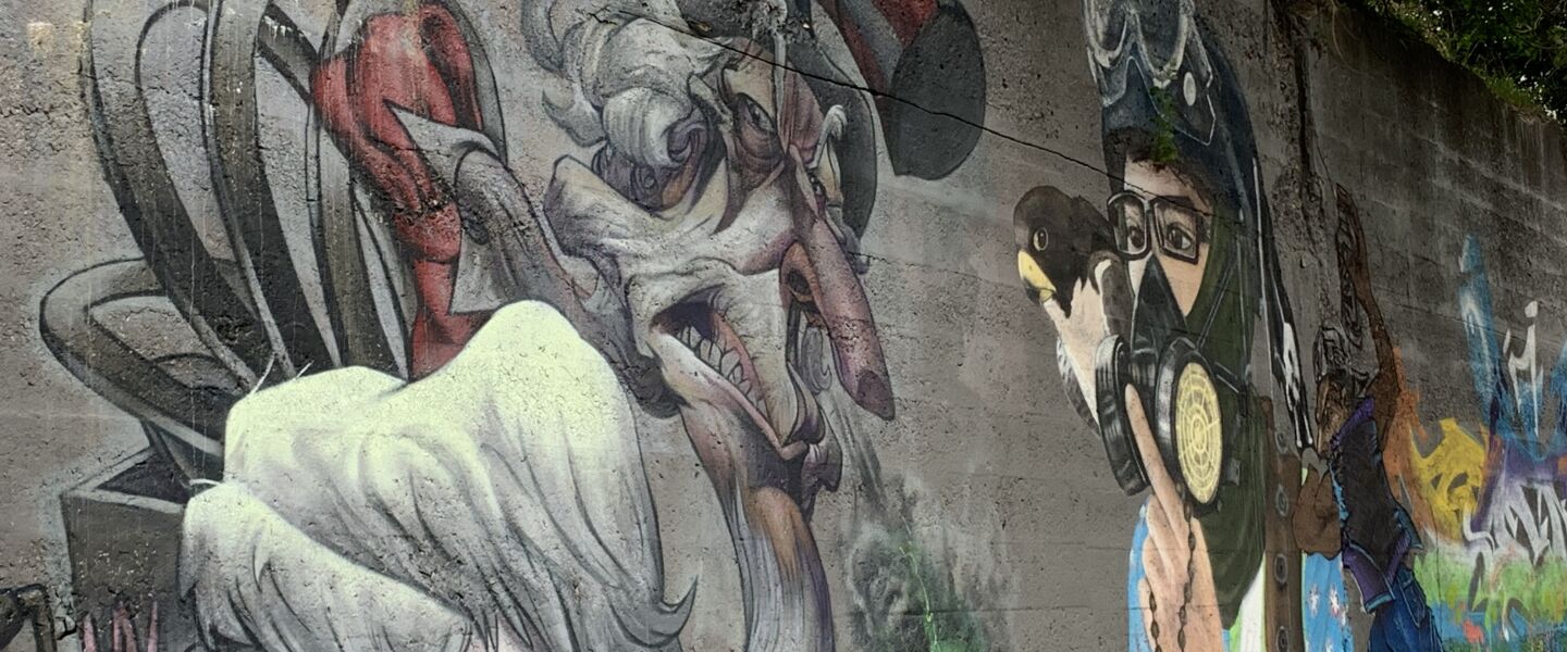 Pilsen artist Jesse Navarrete did this mural on the left, which he calls “Allegory of Corruption,” as a statement about government corruption and also government’s “mismanagement of money.” The art also carries an environmental message, as Uncle Sam is “spewing out very toxic fumes.” The adjacent mural is by Abie Vasquez III.