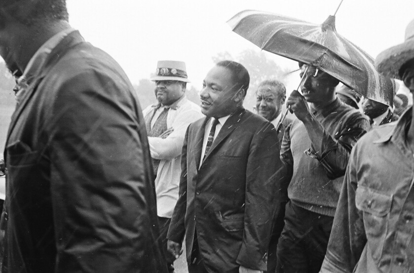 Martin Luther King, Jr. leads march into South Deering in the rain