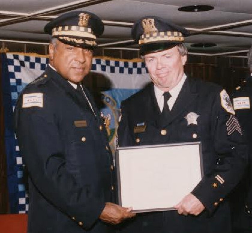 Sgt. Kent Jacobson accepts a commendation from Police Supt. Fred Rice | family photo