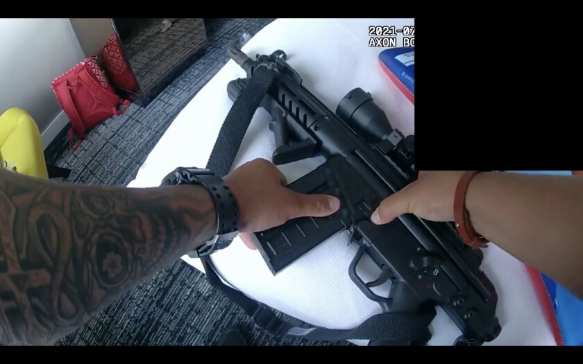 A rifle with an attached scope being recovered by Chicago police inside a downtown hotel room.