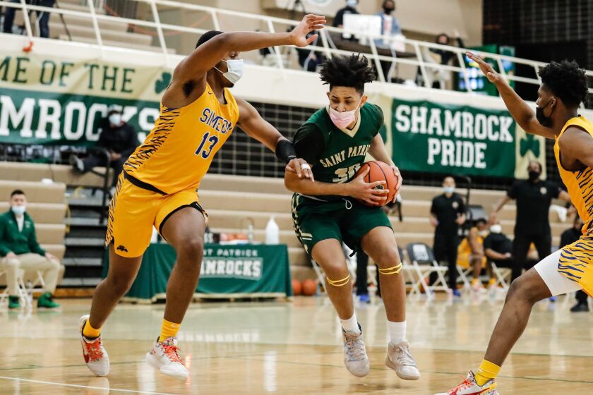 St. Patrick’s Timaris Brown (30) controls the ball as Simeon’s Phillip Holmes jr. (13) defends.