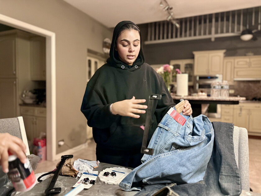 Rabia Amin packs clothing.