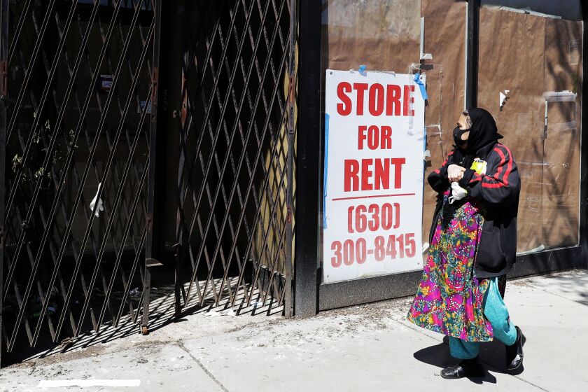 Store for rent sign shows at the closed store in Chicago in May.