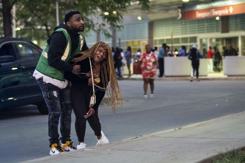 Hundreds of mourners gather in the parking lot of Stroger Hospital after a 40-year-old man was shot to death in the 700 block of North Spaulding Avenue on Memorial Day.
