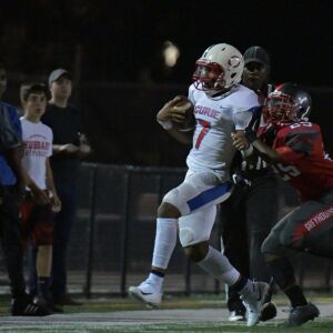 Hubbard’s Jeremiah Terrell (25) pushes Curie’s Damarius Johns (7). Worsom Robinson/For the Sun-Times.
