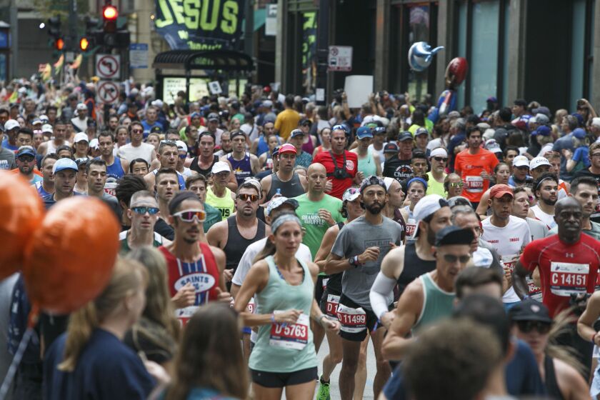 Runners pass through LaSalle Street during the 2021 Chicago Marathon.
