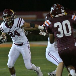 Tyler Flores (24) pushes off for a first down. Worsom Robinson/For the Sun-Times.