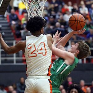 York’s Sam Walsh (35) scores against Whitney Young’s Tyler Beard (24) during their 58-56 loss in Hillside, Wednesday, March 6, 2019. | Kevin Tanaka/For the Sun Times