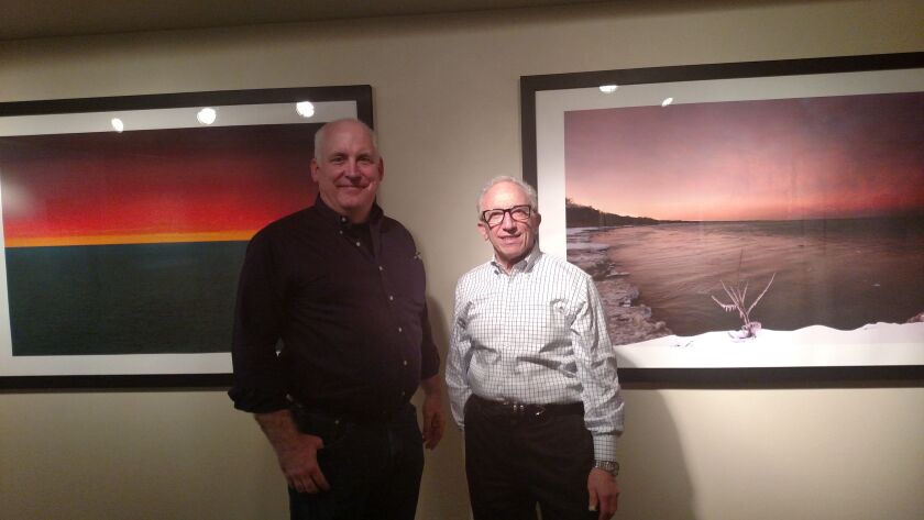 Ted Glasoe and Nelson Armour with their signature photographs at their “Surface Tensions” exhibit on Lake Michigan at the Peggy Notebaert Nature Museum.<br>Credit: Dale Bowman