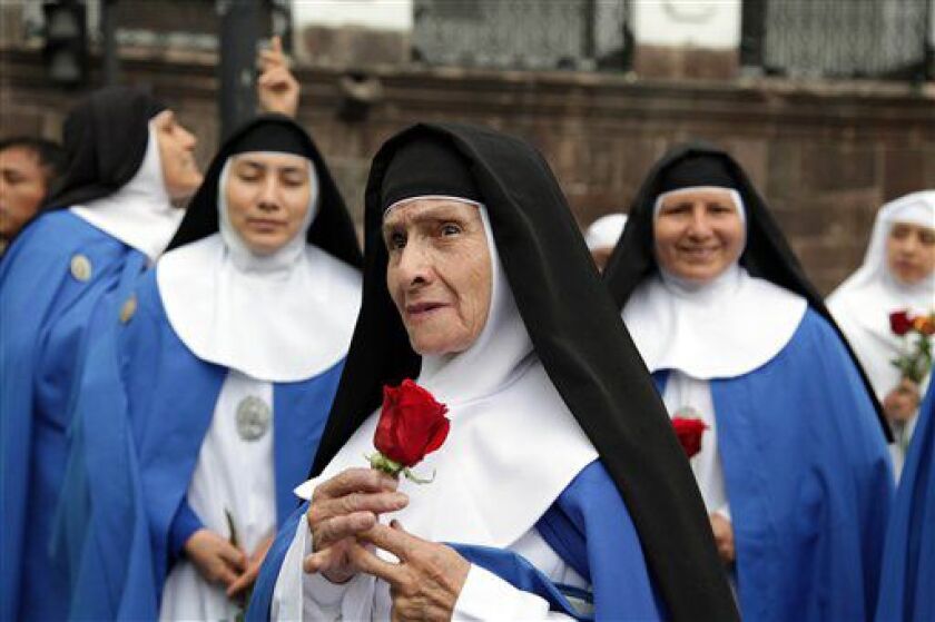 Nuns arrive at Independence square, invited to attend the meeting of Pope Francis and Ecuador’s President Rafael Correa in Quito, Ecuador, on Monday, July 6, 2015. | Ana Buitron/AP