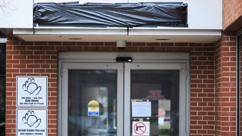 Black plastic covers the emergency room signs at West Suburban Medical Center in Oak Park on Wednesday. The hospital’s majority owner announced he was temporarily closing the hospital last week.