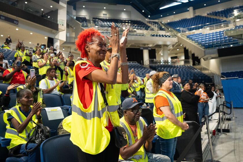 Cynthia Cody, a Safe Passage worker with Black United Fund of Illinois who received an award, claps during a celebration for Safe Passage workers at Wintrust Arena in the South Loop, Tuesday, Aug. 15.