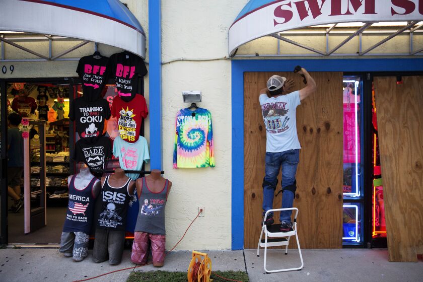 Jone Yoon boards up his beach souvenir shop ahead of Hurricane Irma in Daytona Beach, Fla., on Thursday. South Florida officials are expanding evacuation orders as Hurricane Irma approaches, telling more than a half-million people to seek safety inland. |