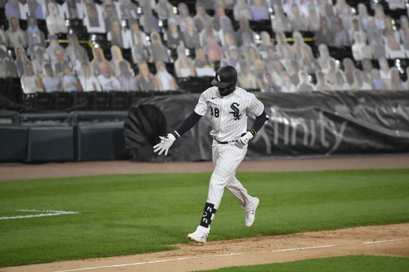 Luis Robert rounds the bases after hitting a home run against the Detroit Tigers at Guaranteed Rate Field in August 2020. There were no fans to cheer him on; those are one-dimensional cutouts attached to the seats.