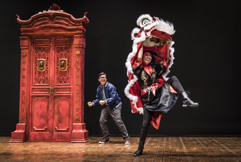 Rammel Chan (left) and Angela Lin (as Lion dancer) in “King of the Yees,” at the Goodman Theatre. | Photo: Liz Lauren