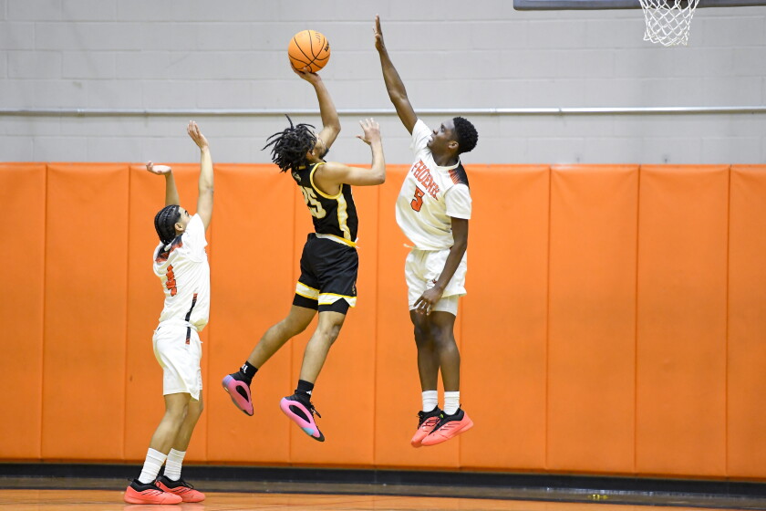 Bowen’s Jeremiah Carter (25) shoots against Little Village's Dion Boyd Jr (5).