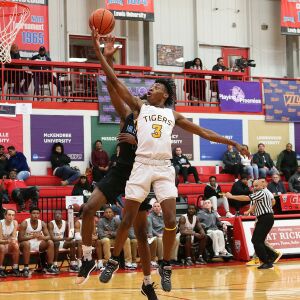 Joliet West’s Jaiden Lee drives to the basket as the Tigers play Hillcrest.