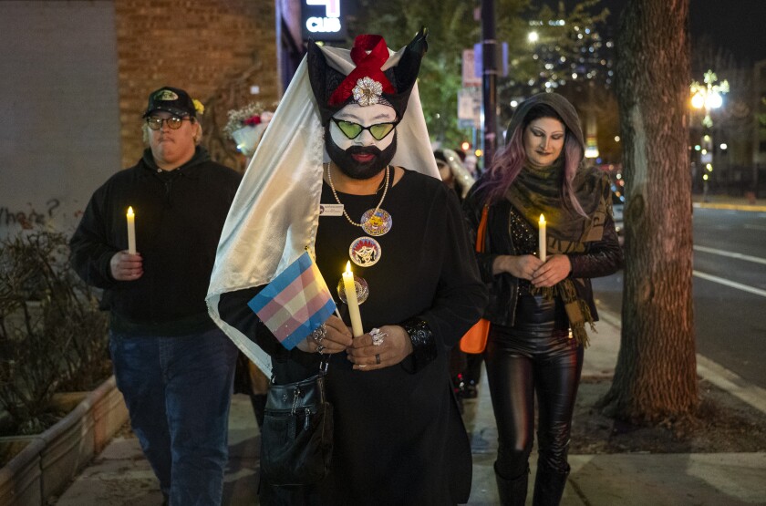 Around 2 dozen people including members of the Sisters of Perpetual Indulgence march along North Halsted Street with electric candles to commemorate Transgender Day of Remembrance, Thursday, Nov. 20, 2025.