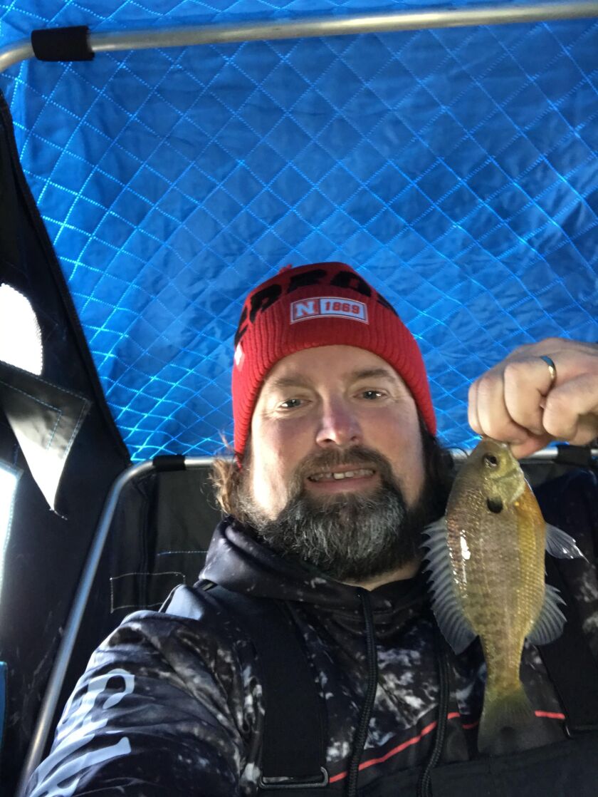 Ken “Husker” O’Malley with a nice bluegill on ice. Provided