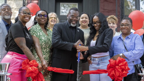 Mayor Brandon Johnson participates in a ribbon cutting with new homeowner Abria Williams and her mother, Martina Brown (far right) to celebrate the renovation of an Engelwood home under the city's Rebuild 2.0 program.