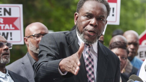 Pastor Ira Acree, who leads Greater St. John Bible Church, speaks during a rally in late May with dozens of religious leaders, health care workers and community members outside West Suburban Medical Center to demand its reopening.