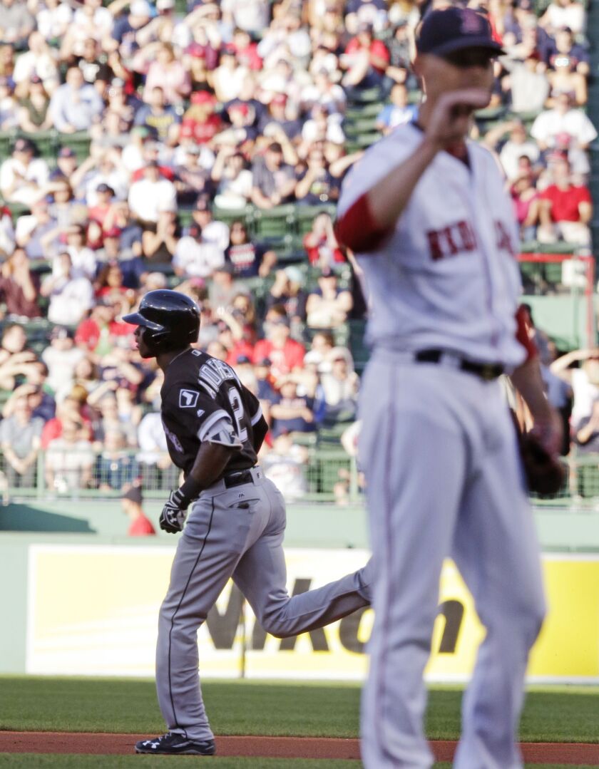 <em>Tim Anderson, left, rounds the bases as Boston Red Sox starting pitcher Clay Buchholz waits for a fresh baseball after a solo home run on the first pitch of the game at Fenway Park. (AP Photo/Charles Krupa)</em>