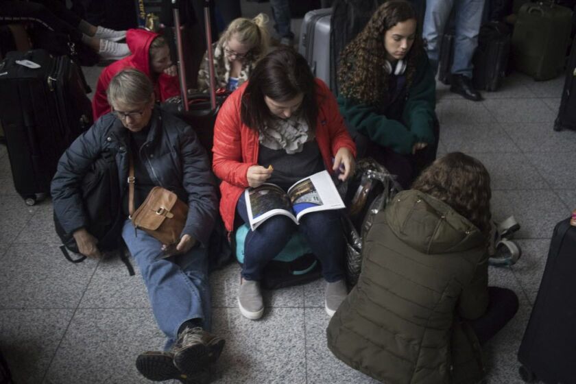 Passengers wait for the lights to come back on at Hartsfield-Jackson International Airport, Sunday, Dec. 17, 2017, in Atlanta. | Steve Schaefer/Atlanta Journal-Constitution via AP