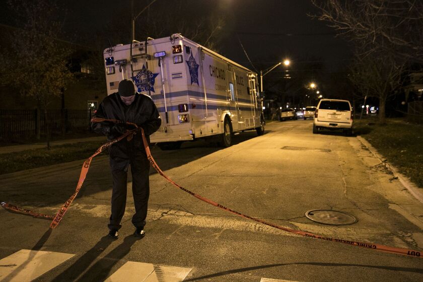 Chicago Police investigate in the 9500 block of South Calumet early Thursday, Dec. 7, 2017. An officer was shot in the hand during a foot pursuit Wednesday night, and taken in good condition to Christ Medical Center in Oak Lawn. | Ashlee Rezin/Sun-Times