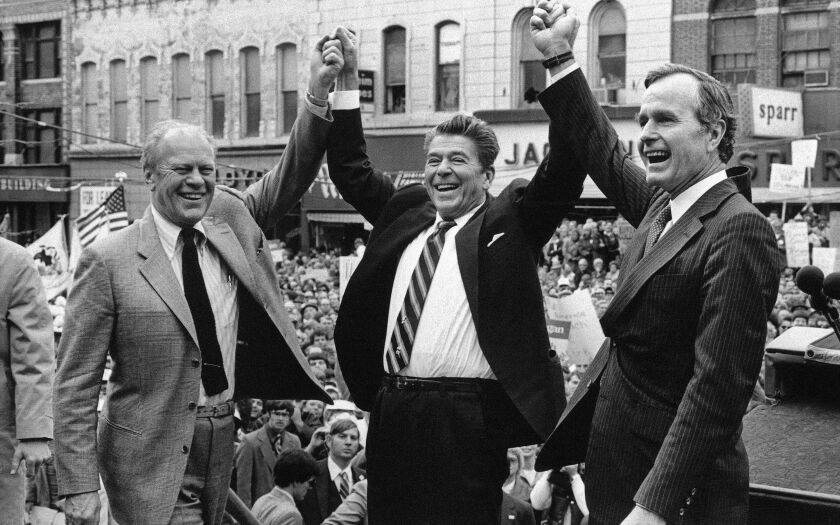 Former President Gerald Ford lends his support to Republican presidential candidate Ronald Reagan and his running mate George H.W. Bush, in Peoria, Ill., in November 1980. | Associated Press