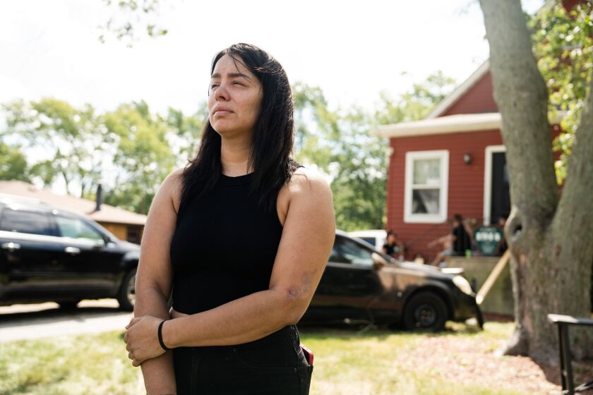 Crystal Chavez talks to a reporter about her husband David Parra and cousin Antonio Munoz, who were both fatally shot early Sunday outside their home in the 500 block of West 14th Street in Chicago Heights, Monday, Sept. 4.