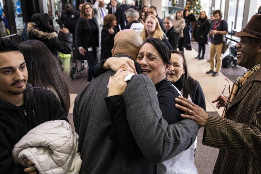 Angelica Nieves hugs attorney Andrew Stroth after a Cook County judge found Chicago Police Officer Lowell Houser guilty of second-degree murder in the 2017 off-duty shooting of her brother Jose Nieves at the Leighton Criminal Courthouse, Friday afternoon,