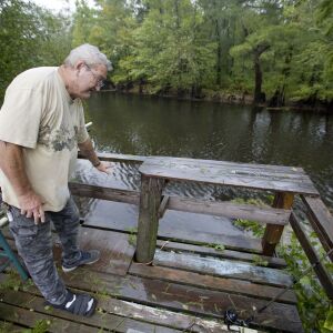 Bennie Todd shows how high the Lumber River rose during Hurricane Matthew two years in his backyard in Lumberton, N.C., Friday, Sept. 14, 2018. Now the town is bracing for another potentially catastrophic flood, as heavy rains from Florence batter the reg