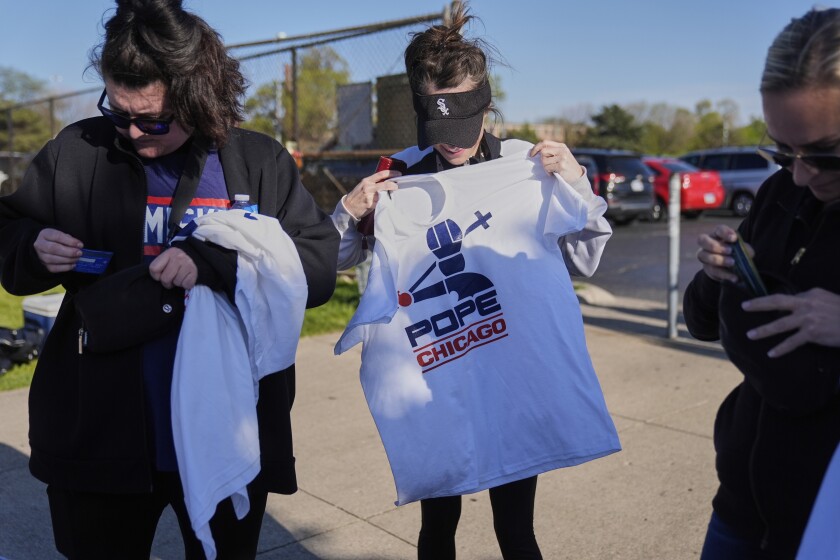 Chicago White Sox fans buy Pope Leo XIV-themed shirts outside Rate Field before a baseball game between the White Sox and Miami Marlins, Saturday, May 10, 2025, in Chicago. (AP Photo/Erin Hooley) ORG XMIT: ILEH308