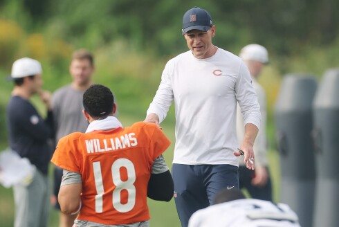 Bears coach Ben Johnson talks with quarterback Caleb Williams during training camp at Halas Hall on July 28, 2025.