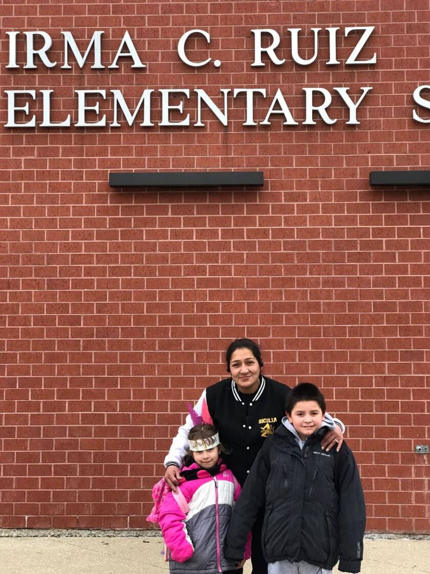 Tania Ibarra (center) and her two grandchildren, Sandra and Frank, outside of Irma C. Ruiz Elementary.