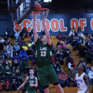 Lane’s Vuk Djuric (33) tries a reverse lay-up against Proviso East, Wednesday 02-27-19. Worsom Robinson/For Sun-Times