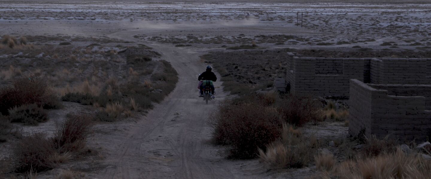 A man drives his motorcycle on a dirt path along the salt-crusted former shoreline of Lake Poopo, in Punaca, Bolivis. For many generations, the homeland of the Uru wasn’t land at all. It was the brackish waters of Lake Poopo.