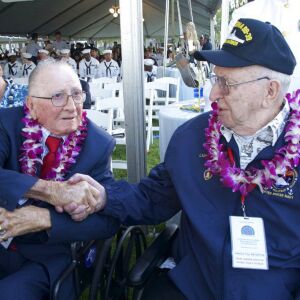 Don Stratton, left, shakes Lauren Bruner’s hand after arrival at ceremonies at the Arizona Memorial in Honolulu, Hawaii. | Craig T. Kojima/The Star-Advertiser via AP