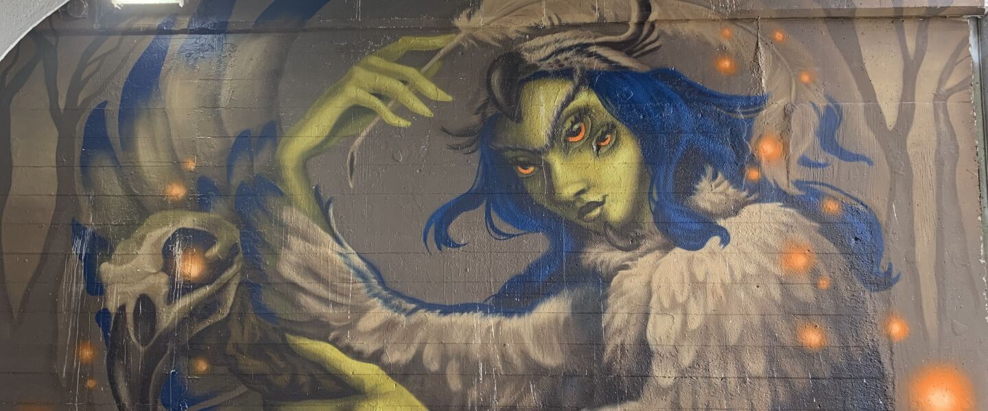 This mural, by Little Village artist Jasmina Cazacu, focuses on “La Chusa,” a “vengeful spirit from Northern Mexican folklore,” according to Cazacu, whose professional name is “Diosa.” A woman “was accused of witchcraft and unjustly murdered for it. Legend has it that, in the afterlife, she was enchanted with the form of an owl, so that she may roam the night and reveal herself as an omen of death to those reminiscent of her murders.”
