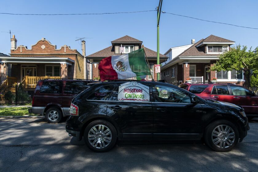 A vehicle zooms through the Little Village neighborhood with its horn blaring and its lights flashing to remind people to fill out their 2020 census.